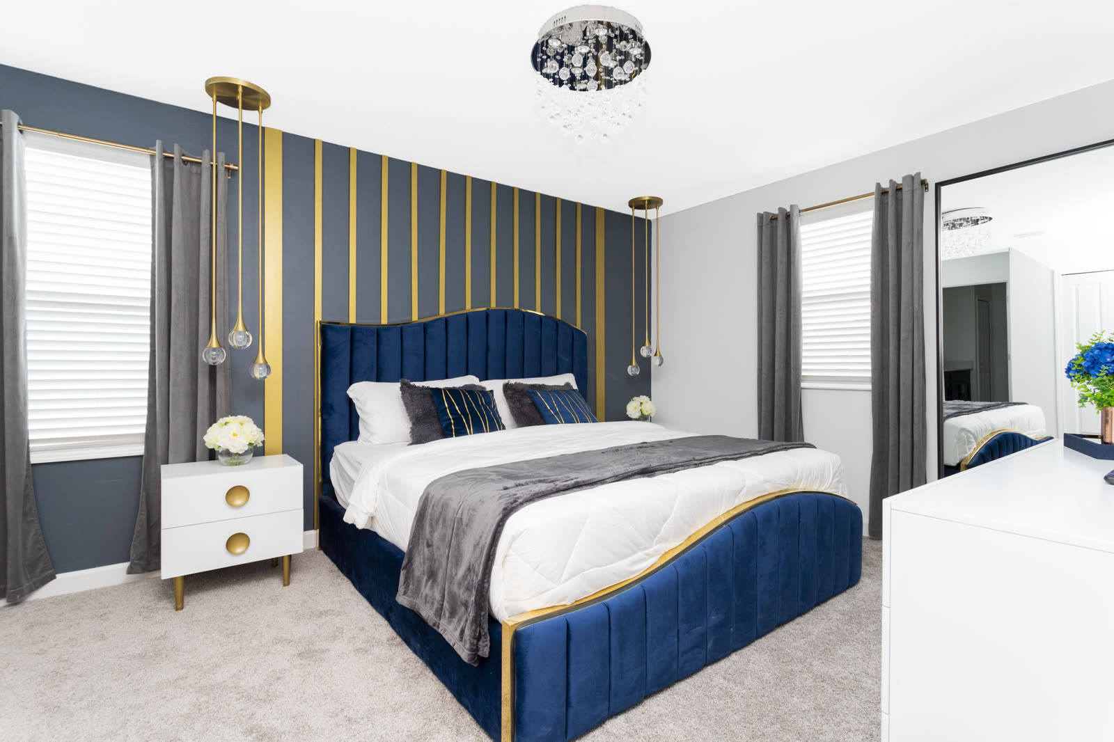 Blue king bedroom with scalloped headboard at The Disney Villa