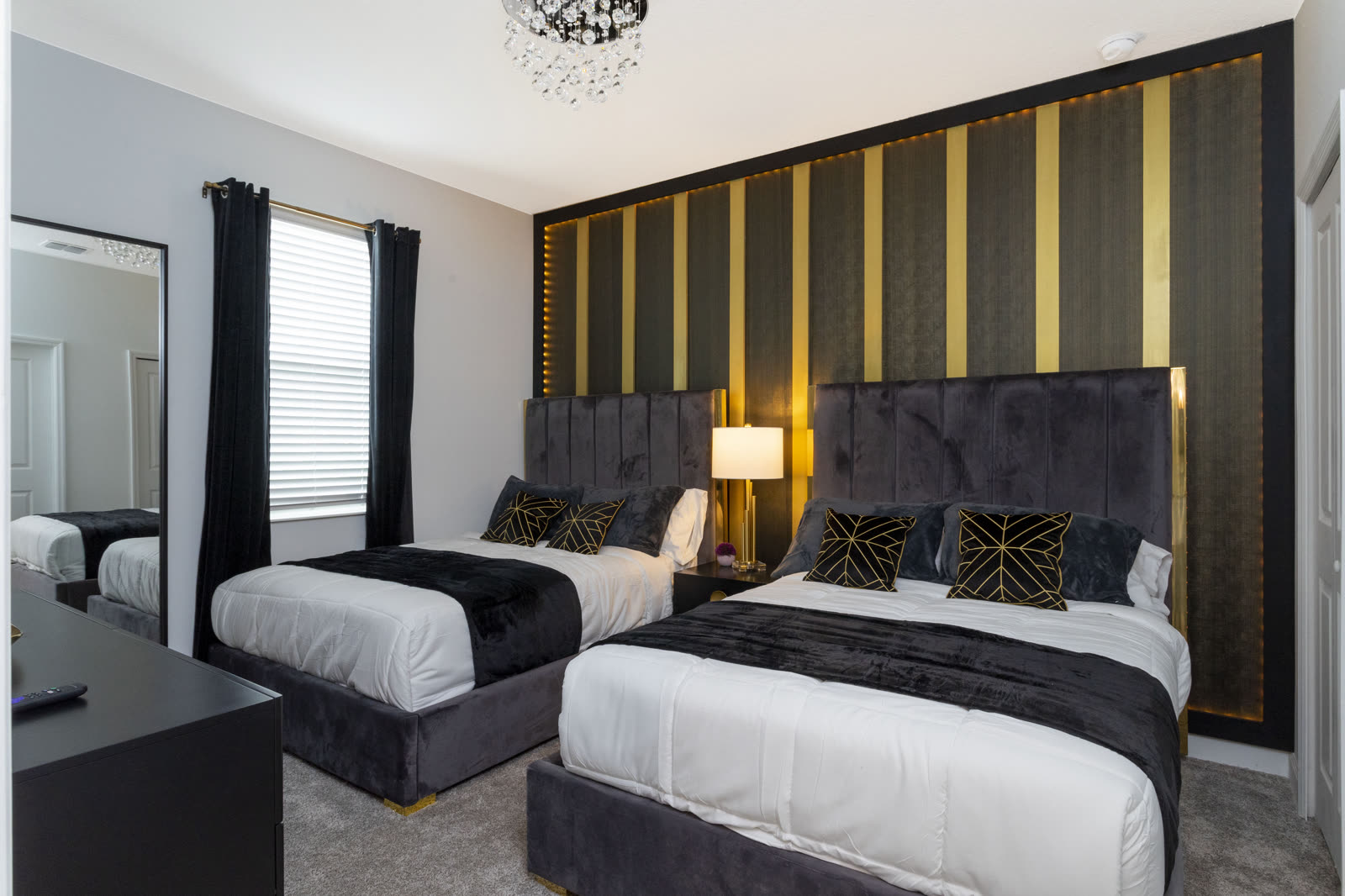 Black and gold bedroom with two double beds at The Disney Villa