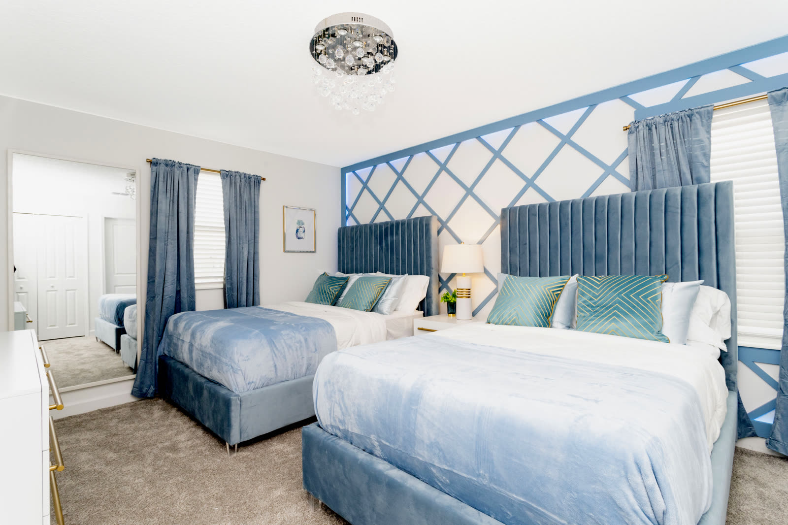 Powder blue bedroom with two double beds at The Disney Villa