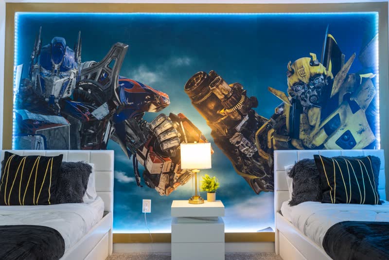 Transformers themed kids' room with Optimus Prime and Bumblebee mural
