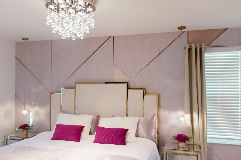 King suite with pink and gold diamond accent wall